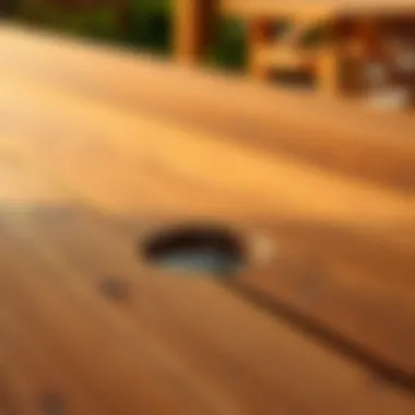 Close-up of a sturdy wooden tabletop featuring an umbrella hole